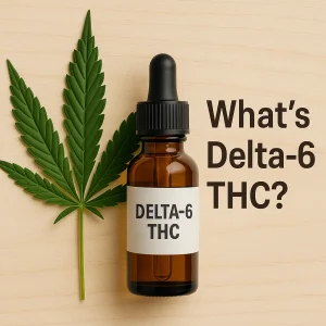Amber dropper bottle labeled “Delta-6 THC” beside a cannabis leaf on a wood surface with the text “What’s Delta-6 THC?”